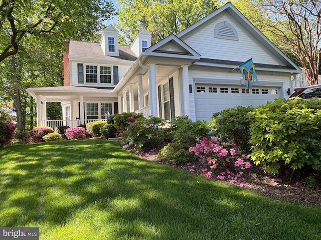 view of front of house featuring an attached garage and a front lawn