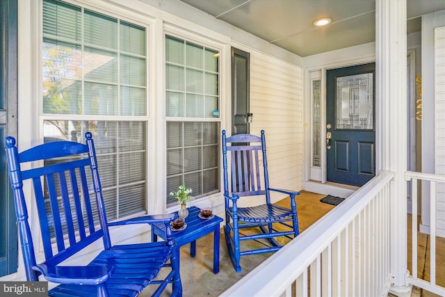 view of exterior entry featuring covered porch