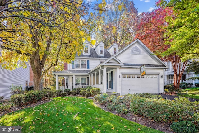 traditional home with aphalt driveway, an attached garage, and a front lawn