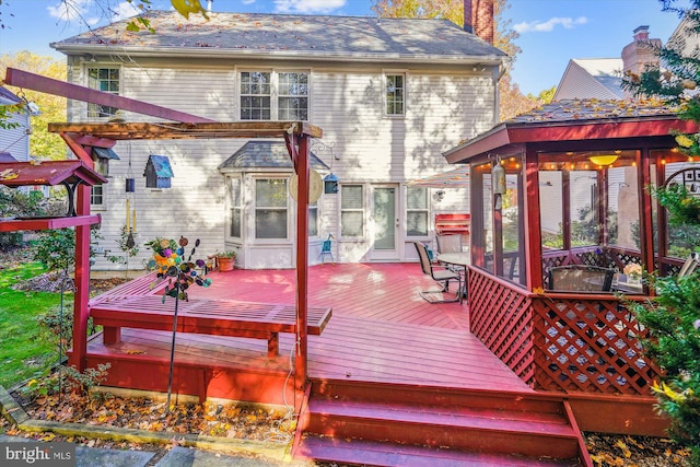 wooden terrace featuring a sunroom