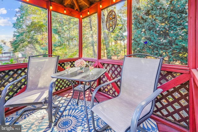 sunroom / solarium with outdoor dining area
