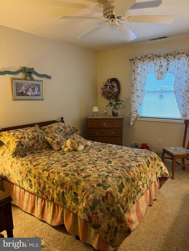 bedroom featuring ceiling fan and carpet