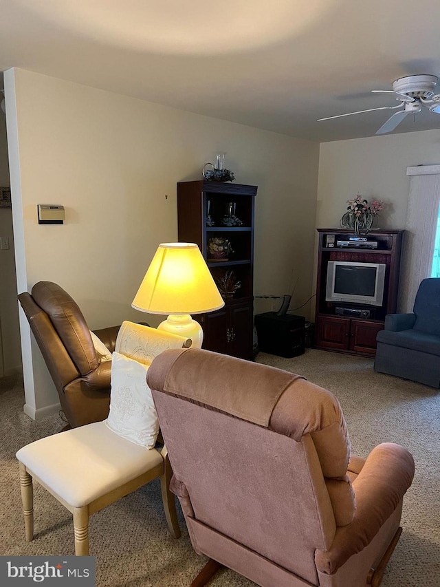 living room with light colored carpet and ceiling fan