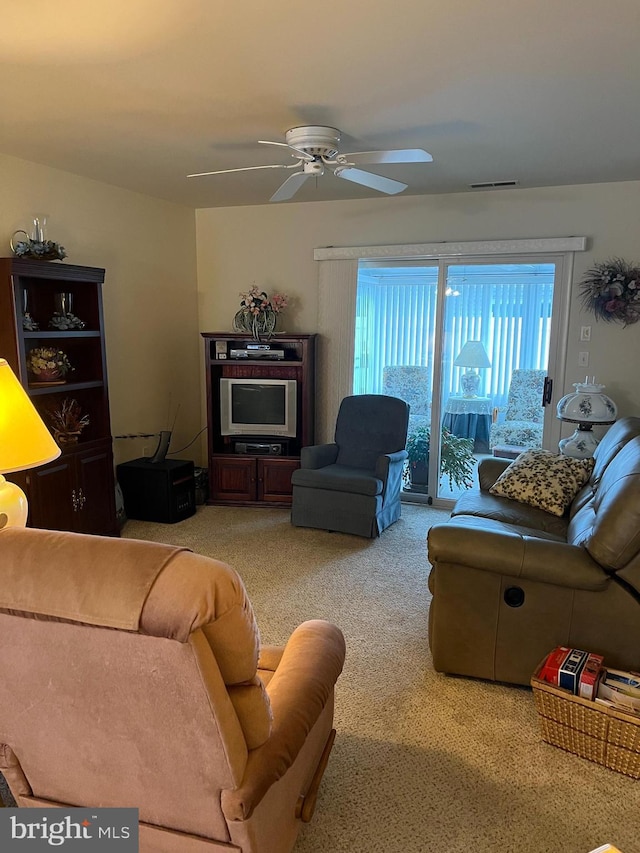 living room featuring light carpet and ceiling fan