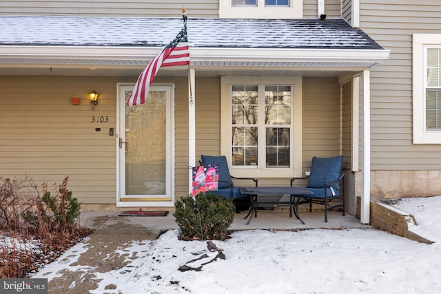 view of snow covered property entrance