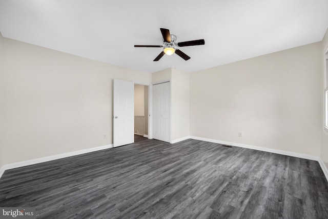 spare room with ceiling fan and dark hardwood / wood-style flooring