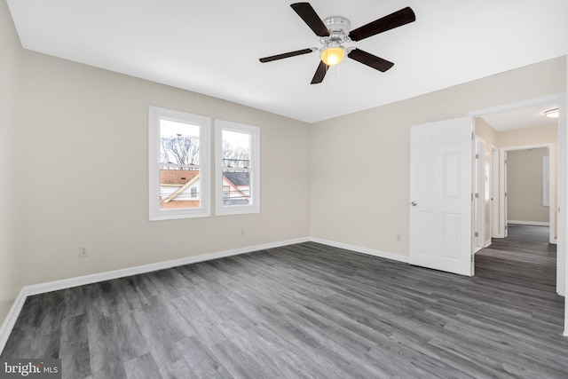 empty room with dark wood-type flooring and ceiling fan