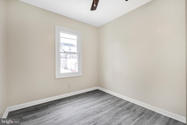 unfurnished room with ceiling fan and dark hardwood / wood-style flooring