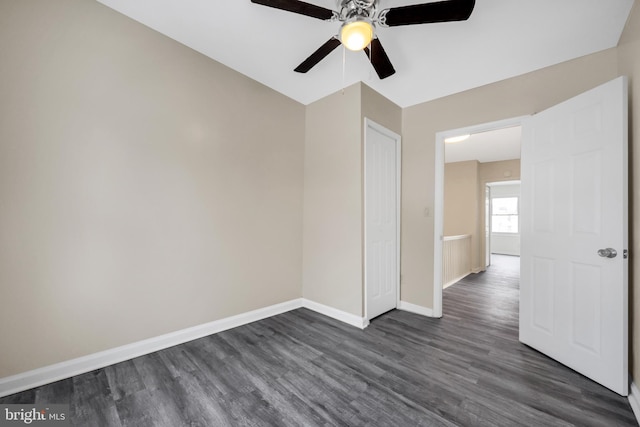 unfurnished room with dark hardwood / wood-style flooring