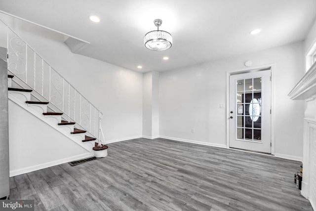 interior space featuring a notable chandelier and wood-type flooring