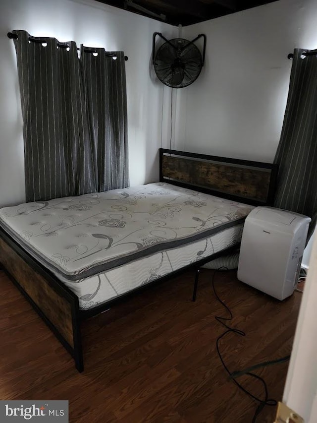 bedroom with dark wood-type flooring