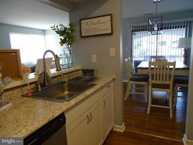 kitchen featuring sink, hanging light fixtures, dark hardwood / wood-style flooring, dishwasher, and a healthy amount of sunlight