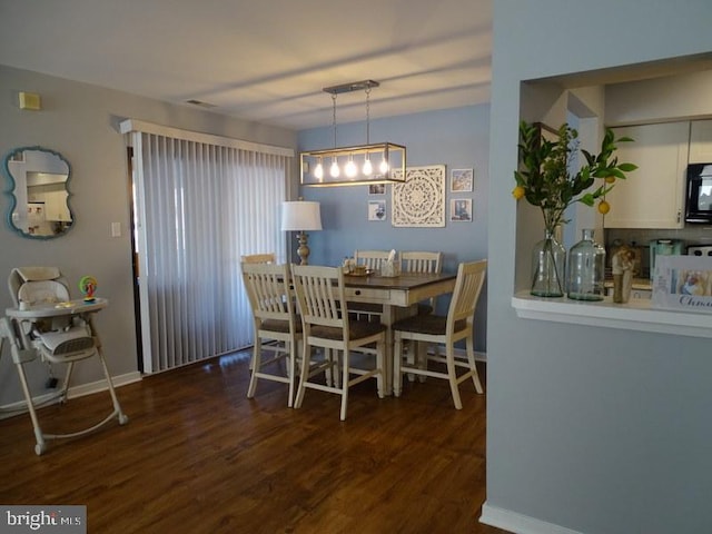 dining area with dark hardwood / wood-style flooring