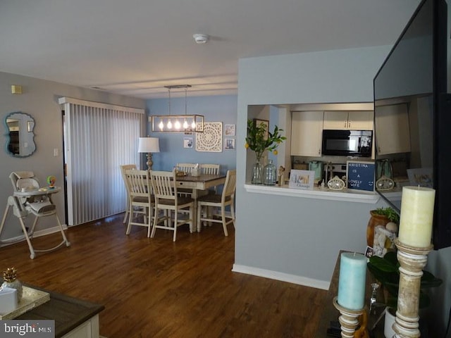 kitchen featuring decorative light fixtures, dark hardwood / wood-style flooring, and a notable chandelier