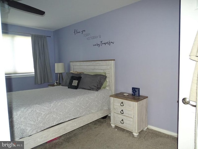 bedroom featuring ceiling fan and dark carpet