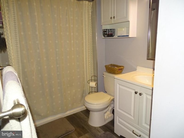 bathroom with vanity, toilet, and hardwood / wood-style floors