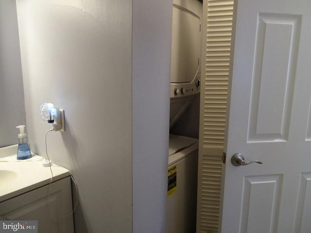 washroom featuring stacked washing maching and dryer