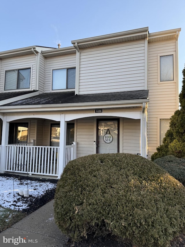 townhome / multi-family property featuring covered porch