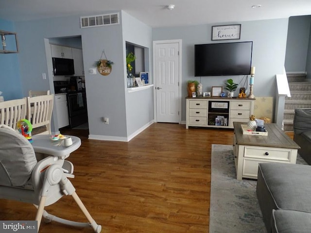 living room featuring dark hardwood / wood-style flooring