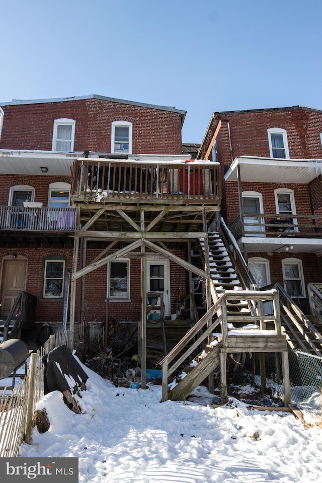 snow covered property featuring a deck