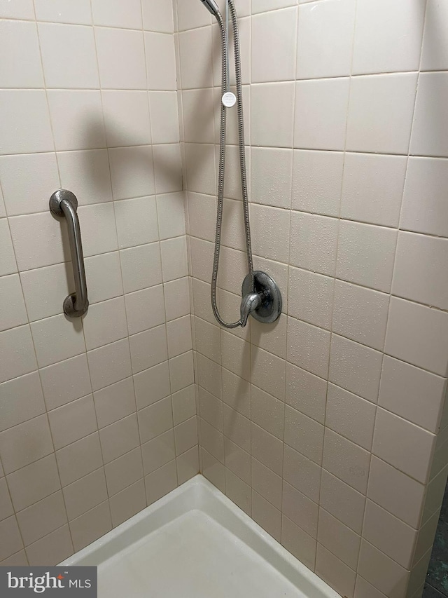 bathroom with tiled shower