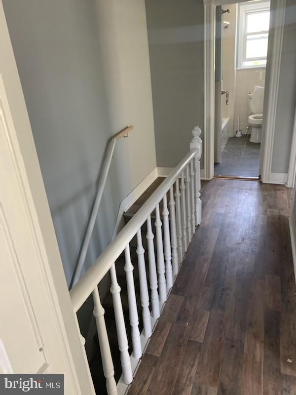 hallway featuring dark wood-type flooring