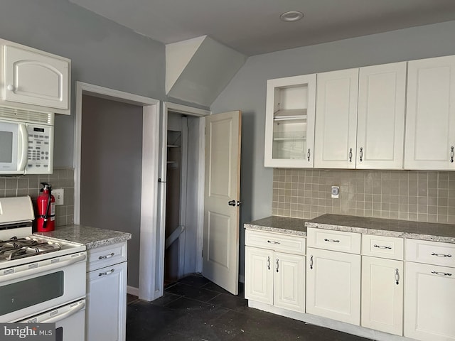 kitchen featuring white cabinets, white appliances, and tasteful backsplash