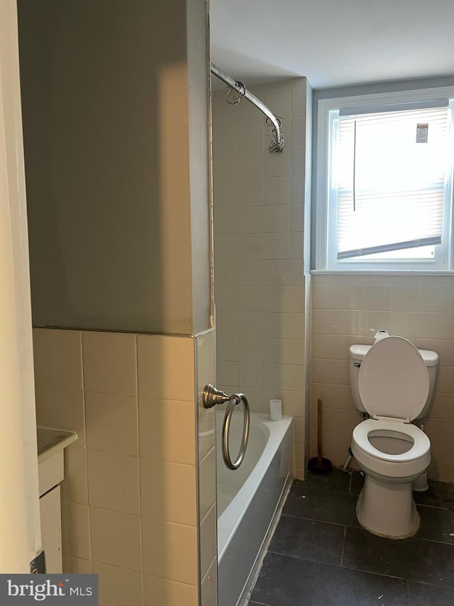 full bathroom with tile patterned flooring, tile walls, toilet, vanity, and shower / bathing tub combination