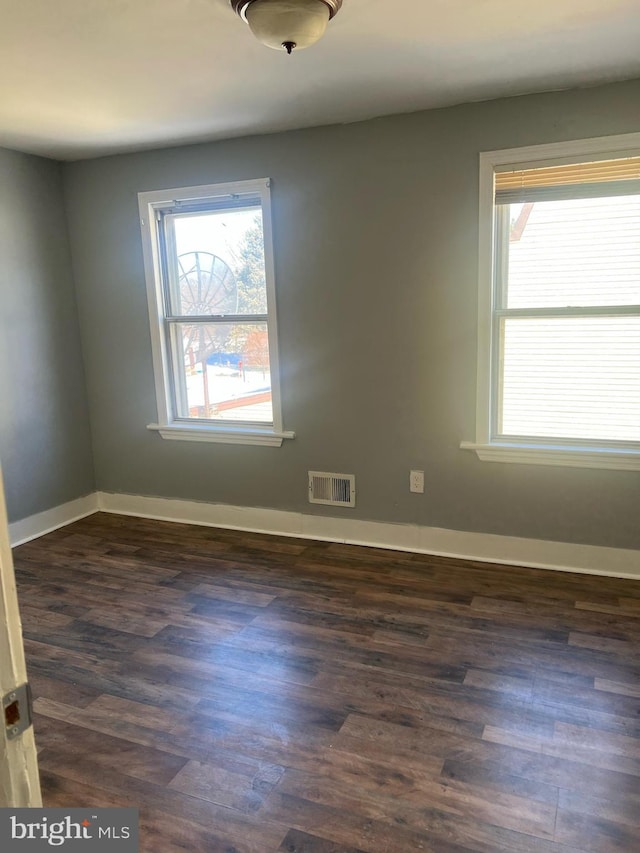 unfurnished room with dark hardwood / wood-style floors