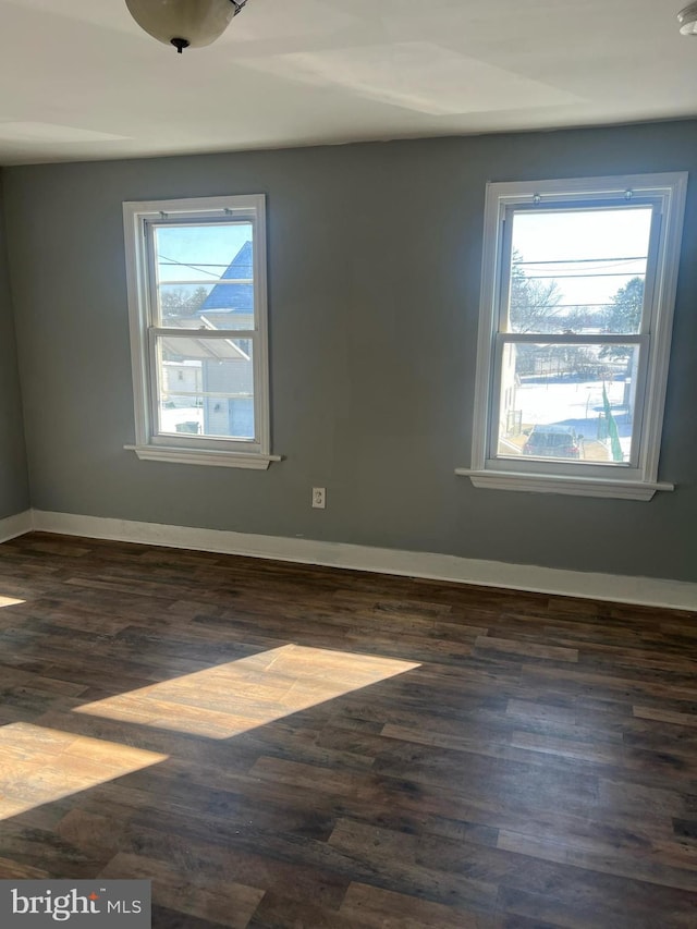 empty room with dark hardwood / wood-style floors