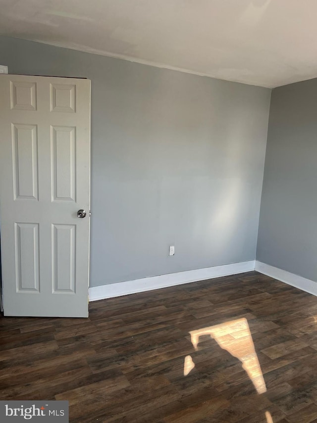 empty room featuring dark hardwood / wood-style floors