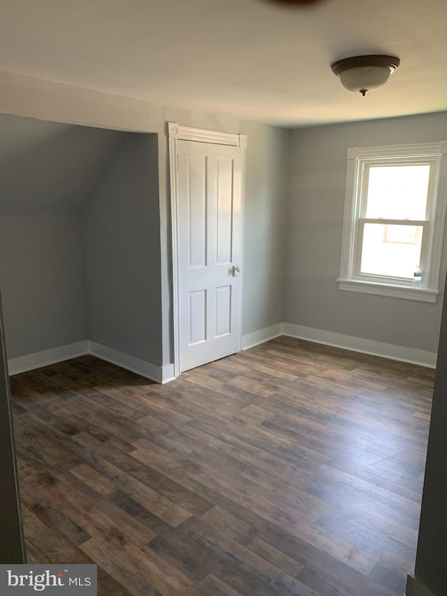 additional living space featuring dark hardwood / wood-style floors