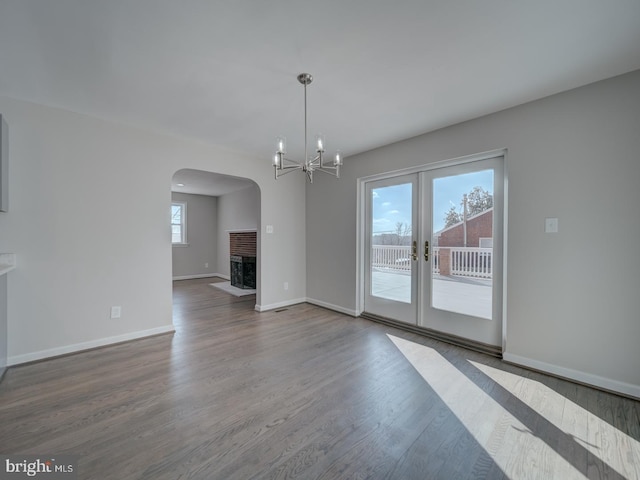 unfurnished living room with french doors, a fireplace, and hardwood / wood-style floors