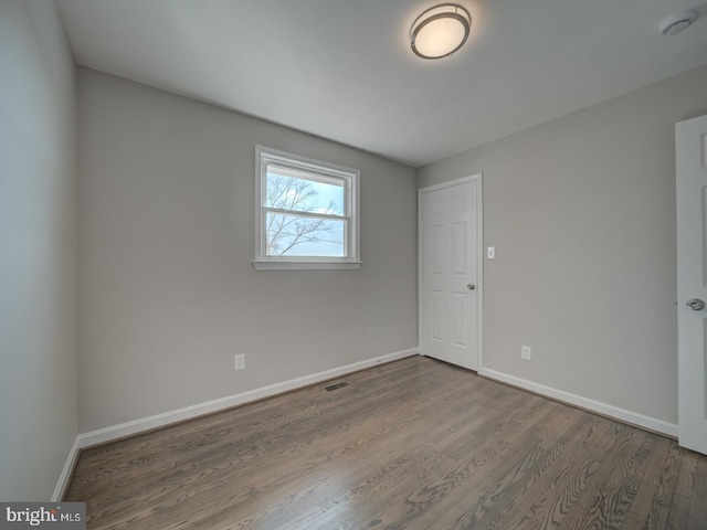 unfurnished room featuring wood-type flooring