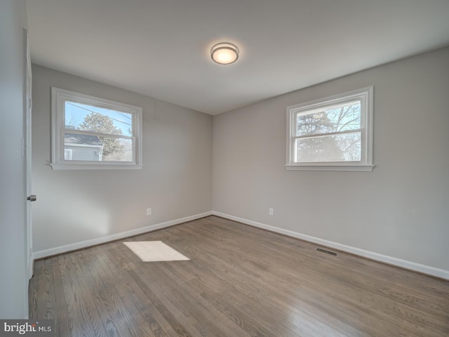 unfurnished room with light wood-type flooring