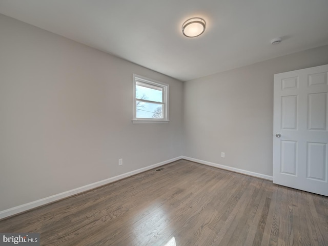 empty room with hardwood / wood-style floors