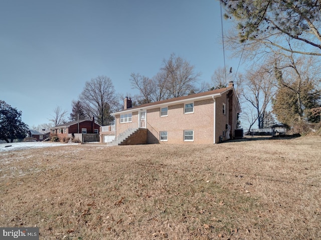 back of house with a lawn