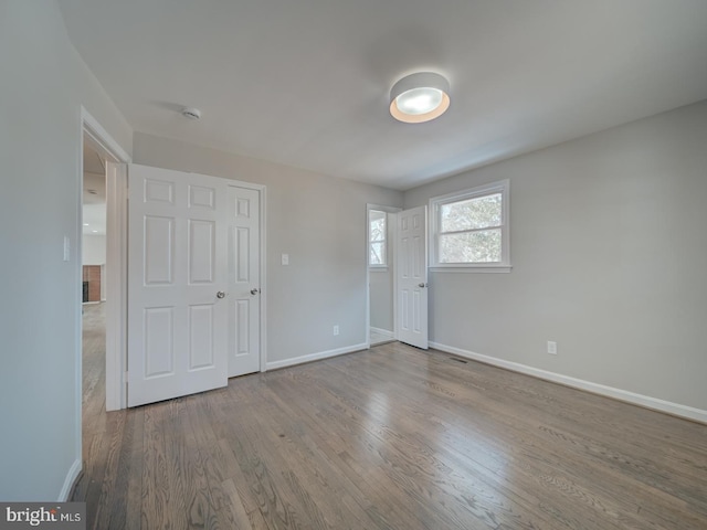 unfurnished room featuring hardwood / wood-style flooring