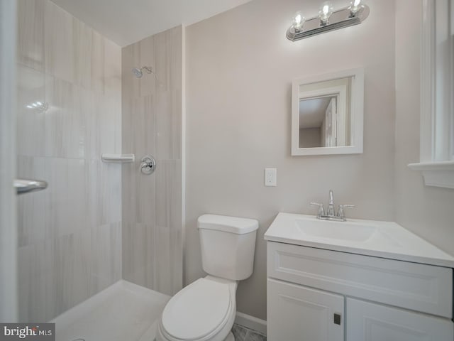 bathroom featuring vanity, toilet, and walk in shower