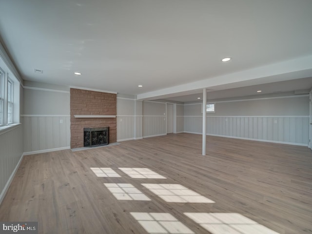 unfurnished living room featuring a fireplace and light wood-type flooring