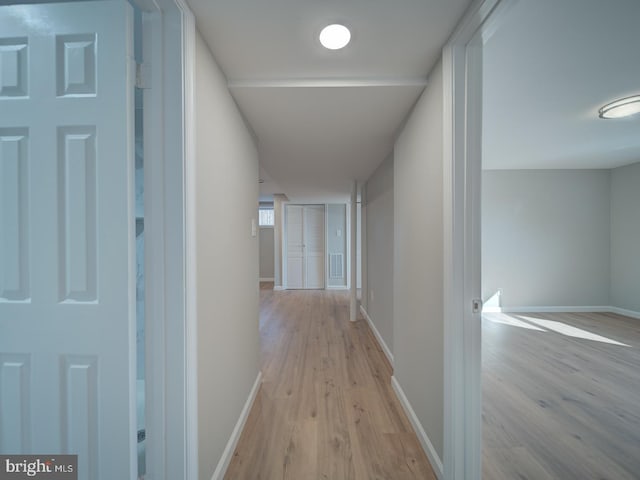 hallway with light hardwood / wood-style floors