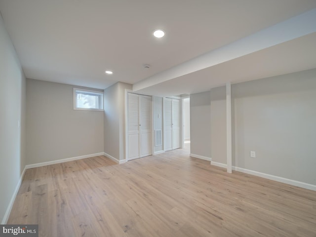 basement with light hardwood / wood-style floors