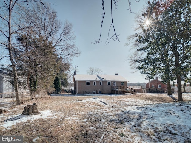 snow covered property featuring a wooden deck