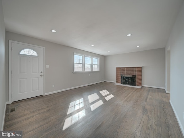 unfurnished living room with a fireplace and hardwood / wood-style floors