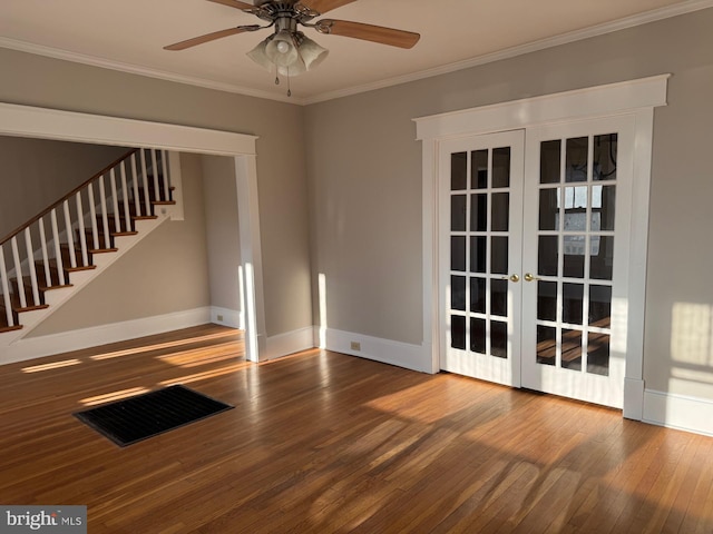 empty room with french doors, ceiling fan, ornamental molding, and hardwood / wood-style flooring