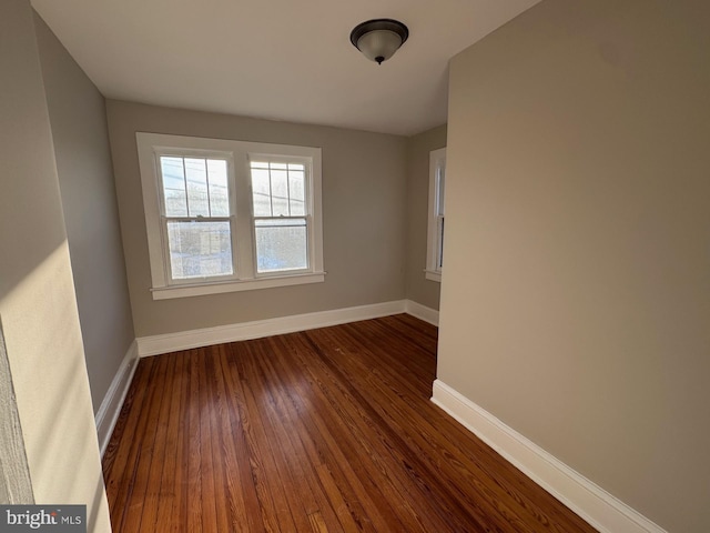 unfurnished room with dark hardwood / wood-style floors