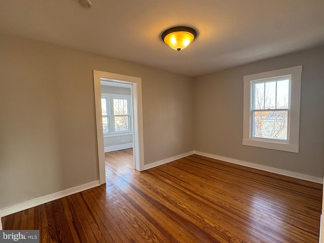 spare room with hardwood / wood-style floors