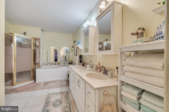 bathroom with tile patterned floors, vanity, and plus walk in shower