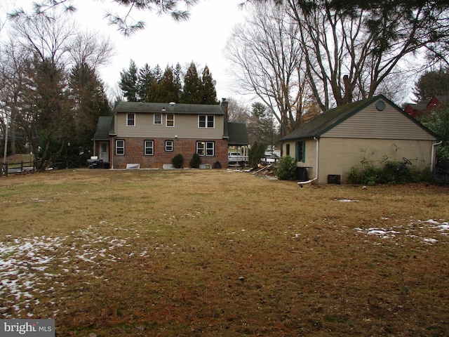 rear view of property with a lawn