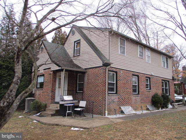 back of house featuring central AC and a patio